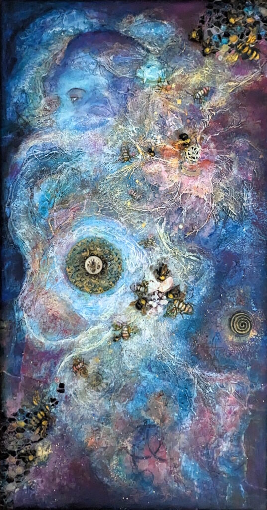This is a photo of a women hidden among pieces of memorabilia and swirling acrylic colors mixed with fiber elements. The color scheme is blue with mixes of purple, and bees (along with honeycombs) are woven into the piece.