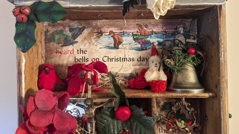 “Christmas in a Box” was inspired through crafting miniature Christmas scenes featuring a radiant Virgin Mary figurine and a vintage Santa peeking out, all set within a festive diorama inspired by childhood nostalgia and holiday traditions.