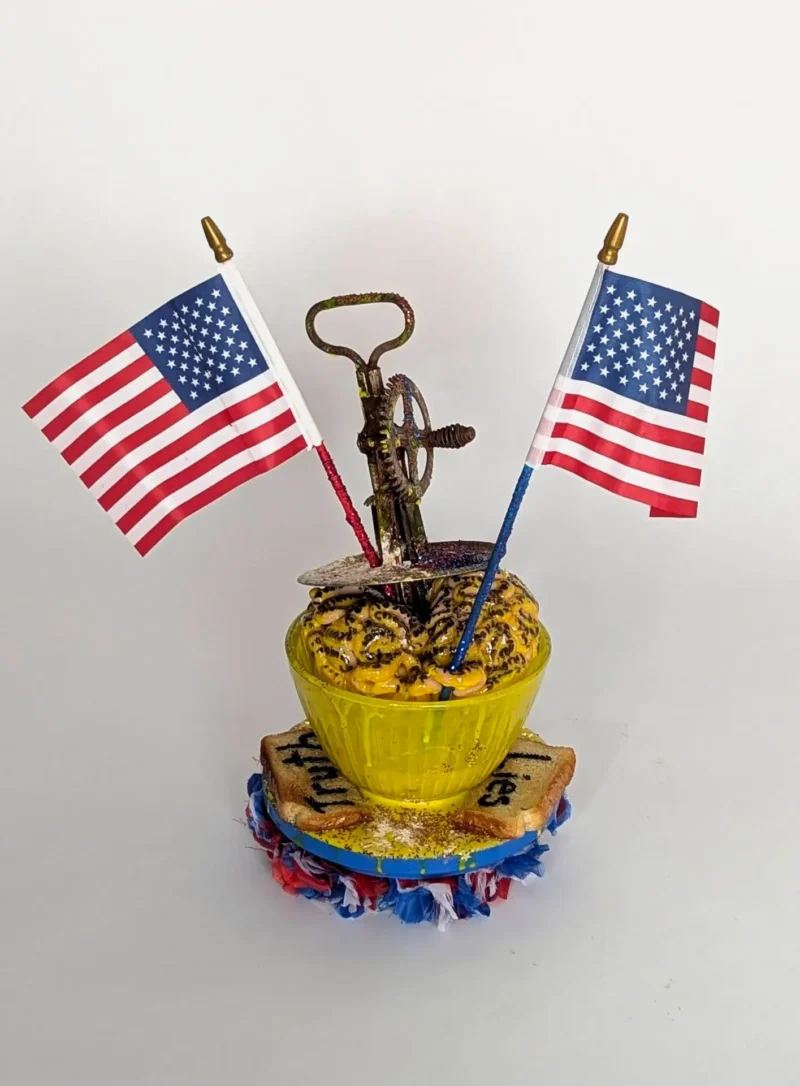 A thought-provoking sculpture depicting two slices of toast labeled "Truth" and "Lies," with a mixing bowl of "scrambled brains" being stirred by a hand mixer. This artwork symbolizes the chaos of misinformation, blurring truth and lies in today's media landscape.